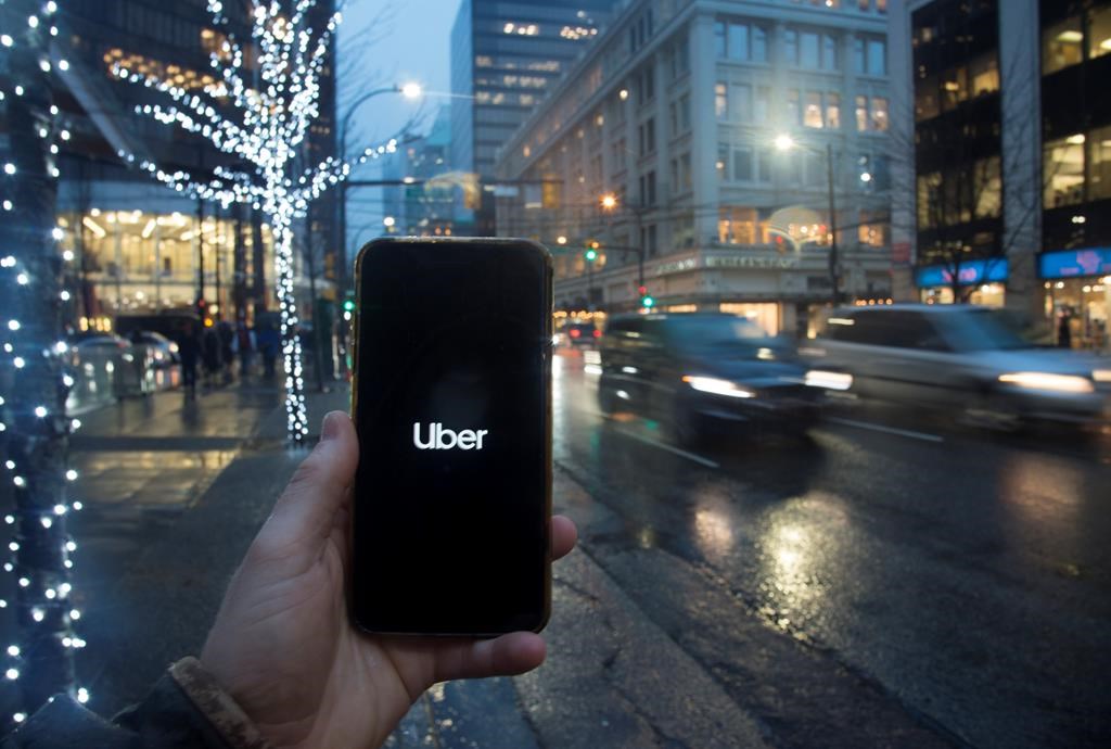 The Uber App is pictured on a smartphone in downtown Vancouver, B.C., Monday, December 30, 2019. British Columbia's Passenger Transportation Board has granted long-awaited licensing approvals to ride-hailing companies Uber and Lyft for service in the Lower Mainland and Whistler. THE CANADIAN PRESS/Jonathan Hayward.