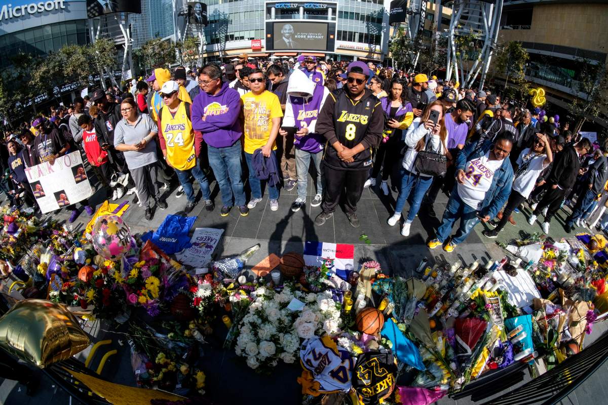 People gather at a memorial for Kobe Bryant near Staples Center Monday, Jan. 27, 2020, in Los Angeles.