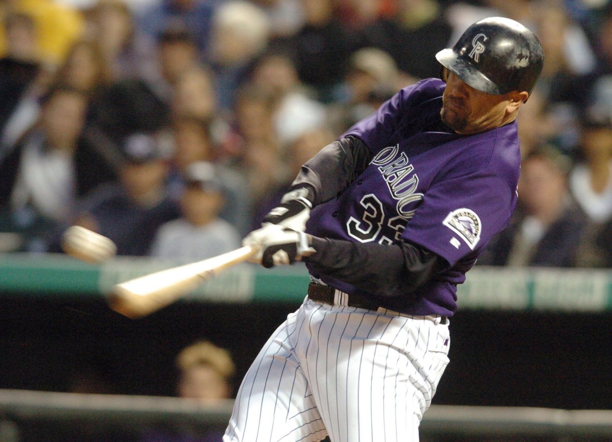 In this 2004 file photo, Colorado Rockies' Larry Walker connects for a double on a pitch from Milwaukee Brewers starting pitcher Ben Sheets in the fourth inning in Denver.