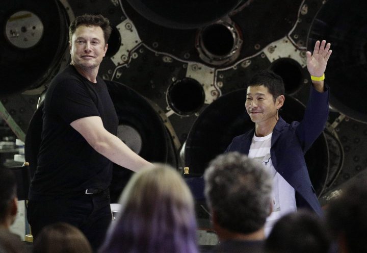 SpaceX founder and chief executive Elon Musk, left, shakes hands with Japanese billionaire Yusaku Maezawa, right, after announcing him as the first private passenger on a trip around the moon, Monday, Sept. 17, 2018, in Hawthorne, Calif.