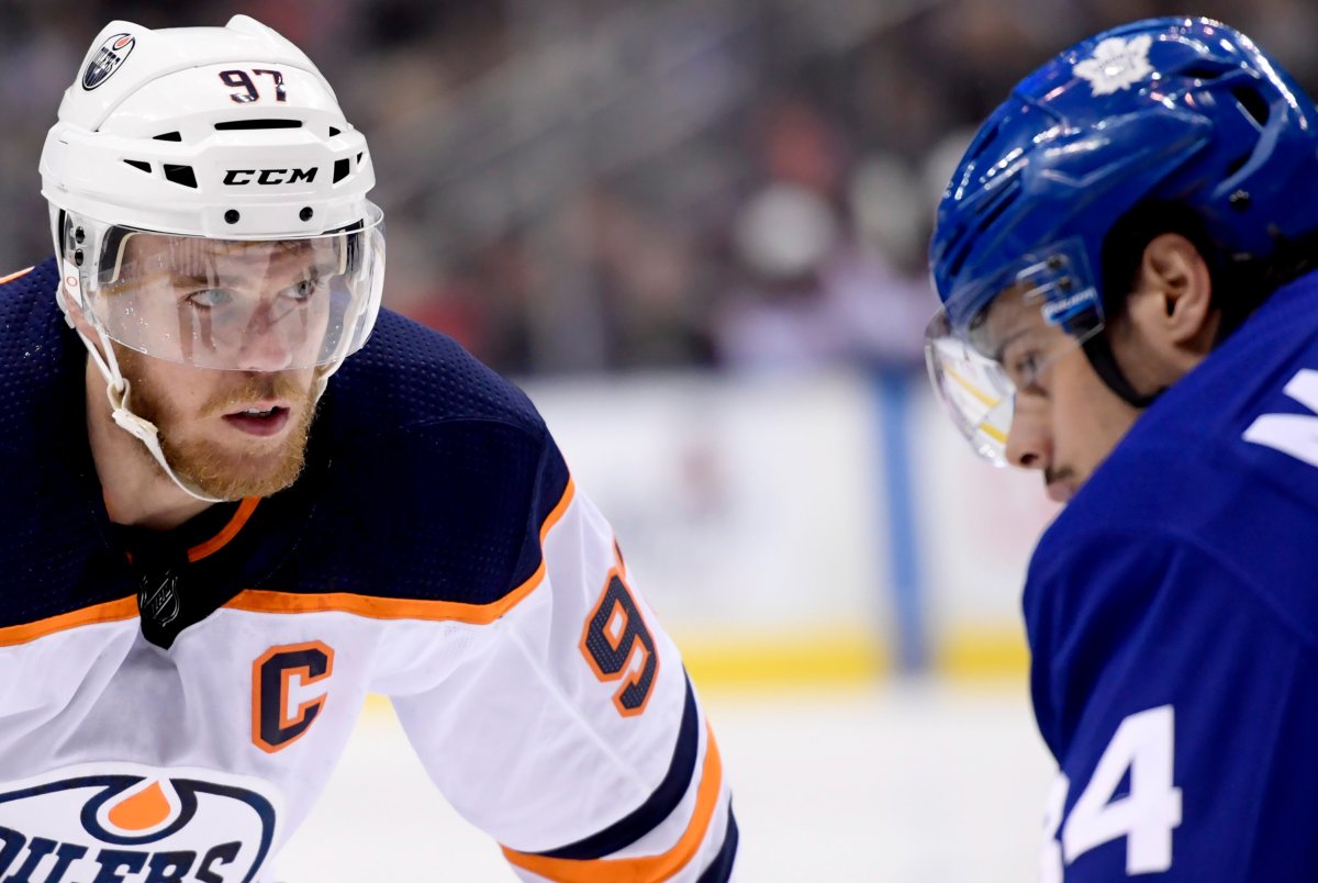 Edmonton Oilers centre Connor McDavid (97) takes a faceoff against Toronto Maple Leafs centre Auston Matthews (34) during first period NHL action in Toronto, Wednesday, Feb. 27, 2019.