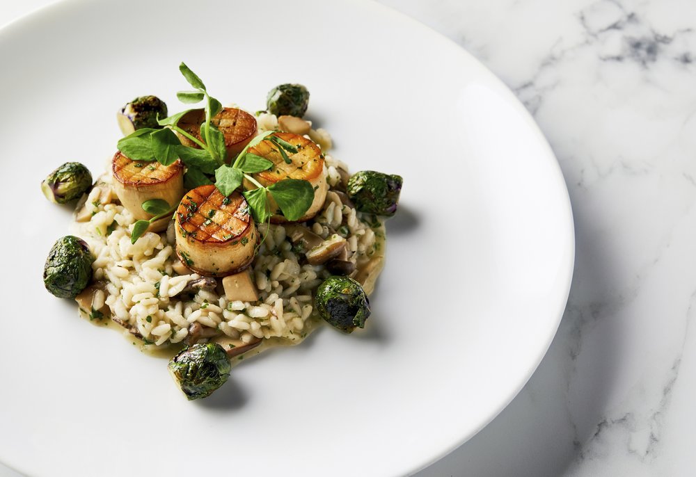 This image released by the Golden Globe Awards shows a dish of king oyster mushroom scallops on a bed of wild mushroom risotto with roasted Brussels sprouts, prepared by Beverly Hilton Executive Chef Matthew Morgan. The dish will be served at the Golden Globe Awards on Sunday.