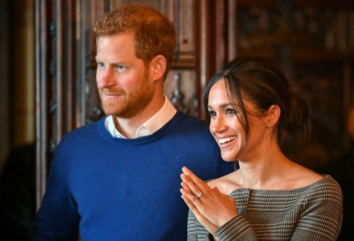 Prince Harry and Meghan Markle watch a performance by a Welsh choir in the banqueting hall during a visit to Cardiff Castle in 2018.