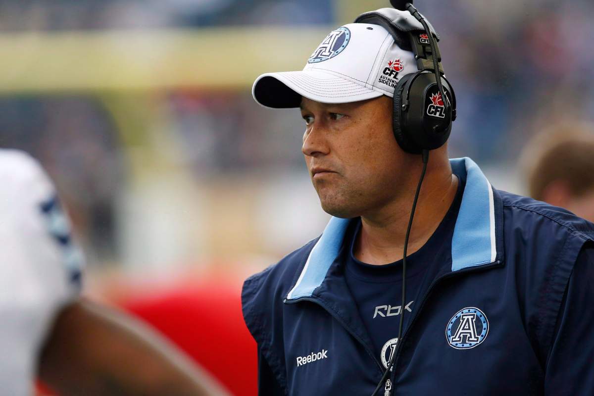 Toronto Argonauts head coach Scott Milanovich stands on the sidelines during the first half of CFL action against the Winnipeg Blue Bombers in Winnipeg on June 26, 2014. Milanovich expects to remain the head coach of the Toronto Argonauts. Speculation has swirled the last two months regarding Milanovich’s future with the Argos amid reports he’d become frustrated with the franchise’s nomadic existence prior to moving into its new permanent practice facility at Downsview Park. THE CANADIAN PRESS/John Woods