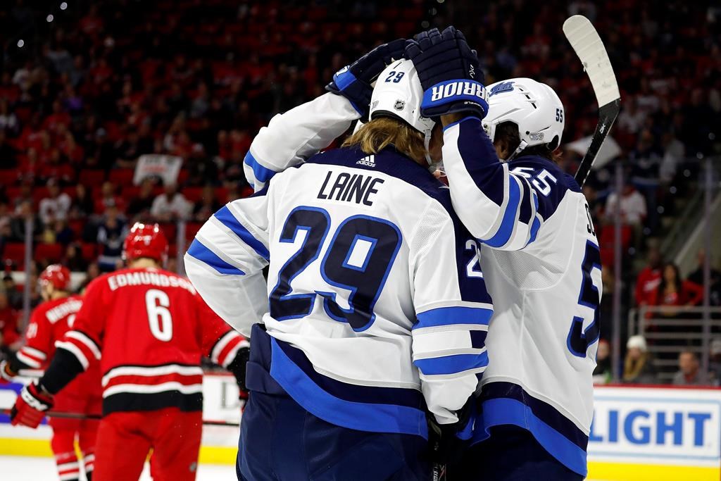 The Winnipeg Jets celebrate a goal by Patrik Laine (29) against the Carolina Hurricanes during the first period of an NHL hockey game in Raleigh, N.C., Tuesday, Jan. 21, 2020. (AP Photo/Karl B DeBlaker).