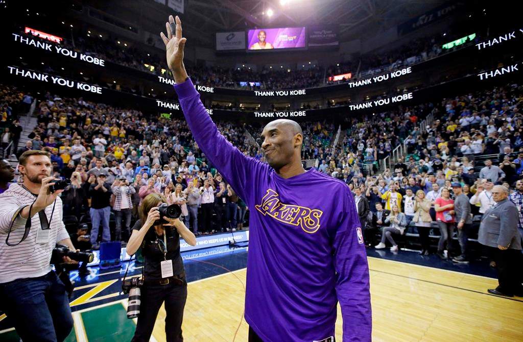 In this March 28, 2016, file photo, Los Angeles Lakers forward Kobe Bryant waves to fans before the start of an NBA game against the Utah Jazz, in Salt Lake City.