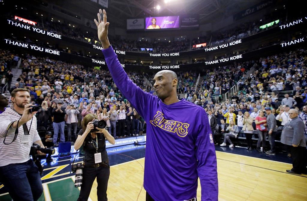 In this March 28, 2016, file photo, Los Angeles Lakers forward Kobe Bryant waves to fans before the start of an NBA game against the Utah Jazz, in Salt Lake City.