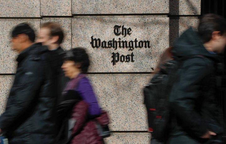 FILE - In this Thursday, Feb. 21, 2019, file photo, people walk by the One Franklin Square Building, home of The Washington Post newspaper, in downtown Washington. Washington Post political reporter Felicia Sonmez, who had been placed on administrative leave after she tweeted a link to a story about a 2003 rape allegation against Kobe Bryant, has been cleared to return to work, the paper said Tuesday, Jan. 28, 2020. (AP Photo/Pablo Martinez Monsivais, File).
