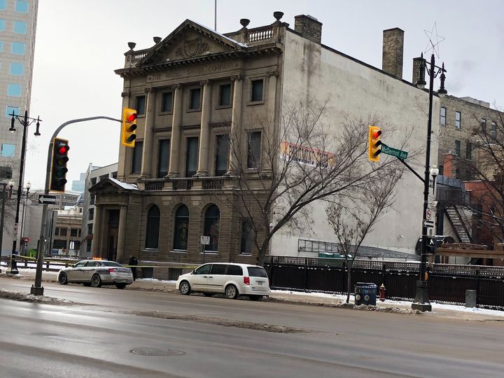 Police tape lines the sidewalk outside of a Winnipeg nightclub, the likely scene of a New Year’s Eve assault.