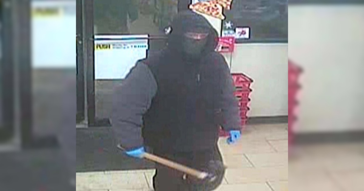 The suspect is shown entering a North Battleford business with a weapon in this handout photo from police.