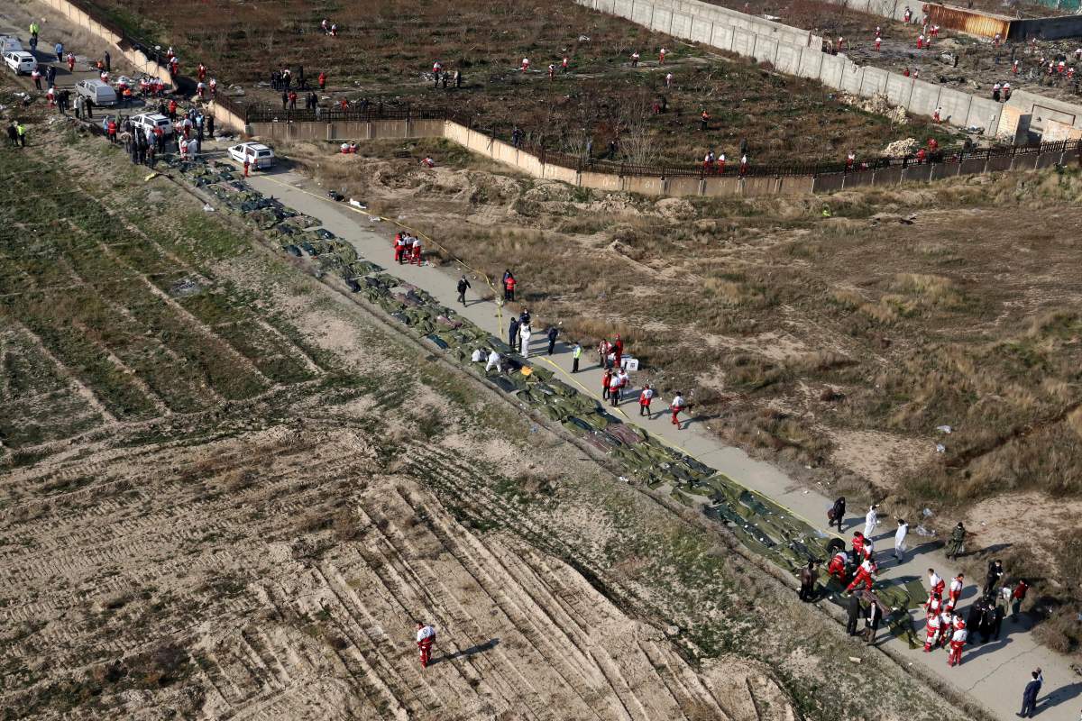 Bodies of the victims of a Ukrainian plane crash are collected by rescue teams at the scene of the crash in Shahedshahr, southwest of Tehran, Iran, on Wednesday, Jan. 8, 2020. (AP Photo/Ebrahim Noroozi)