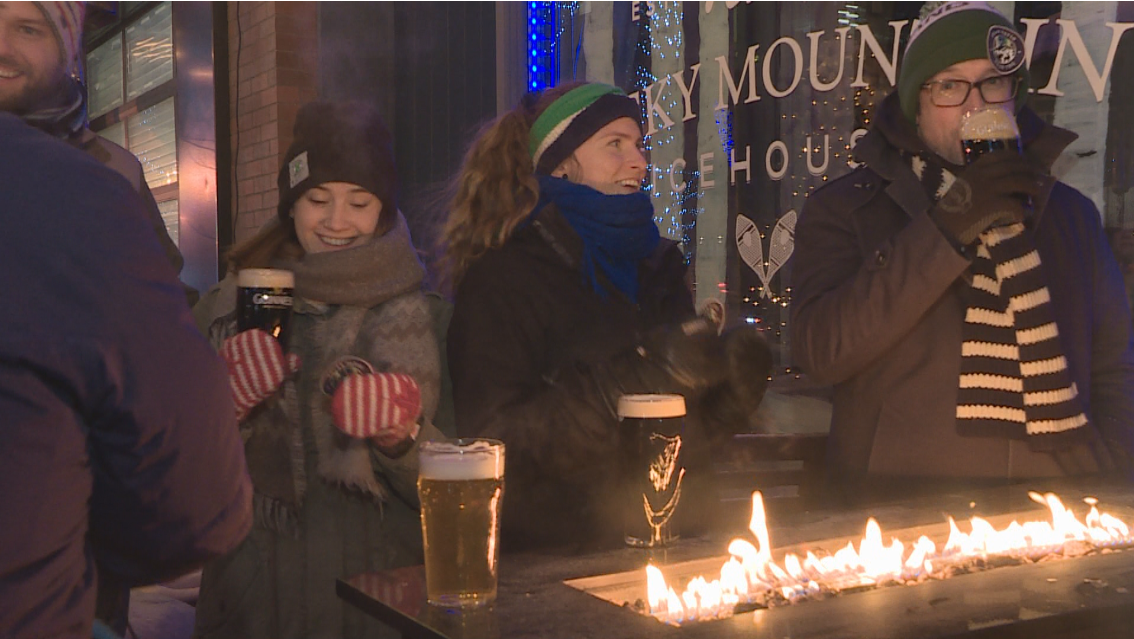 Members of the Polar Patio Club attempt to have a drink outside on one of the coldest nights in Edmonton. 