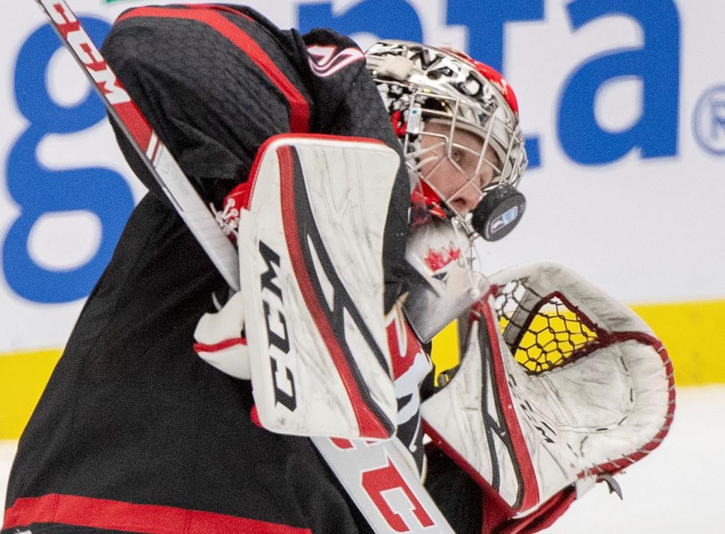 Canada goaltender Joel Hofer takes a shot off the mask during third-period semifinal action against Finland at the world junior hockey championship on Saturday, Jan. 4, 2020 in Ostrava, Czech Republic. THE CANADIAN PRESS/Ryan Remiorz