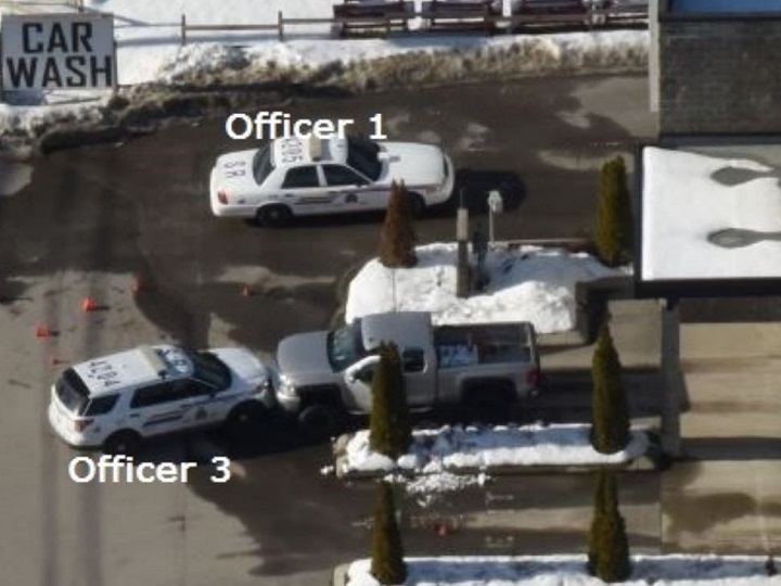 A photo showing two RCMP vehicles and the plaintiff’s truck following a police shooting at a Salmon Arm car wash in 2017.
