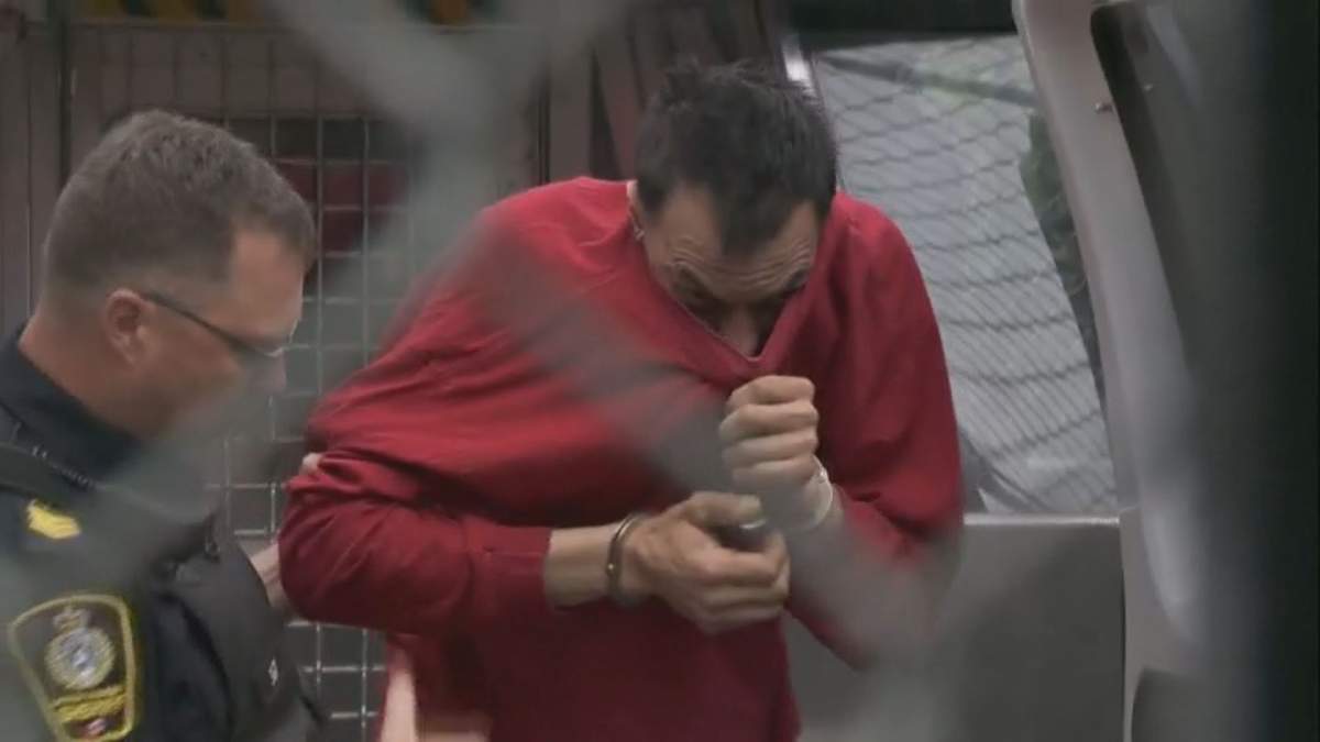 Kehar Garry Sangha hides his face during a bail hearing in July 2019. 