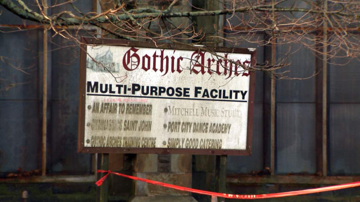 An old sign about one of the structure’s past lives remained outside until demolition began.