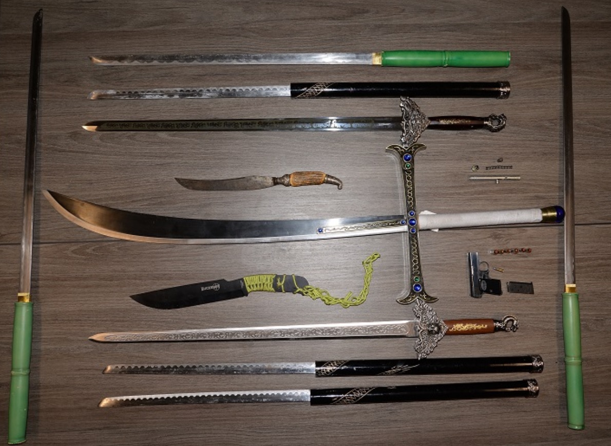 St. Thomas police say officers seized a loaded handgun, ammunition and several large swords after searching a storage unit in London.