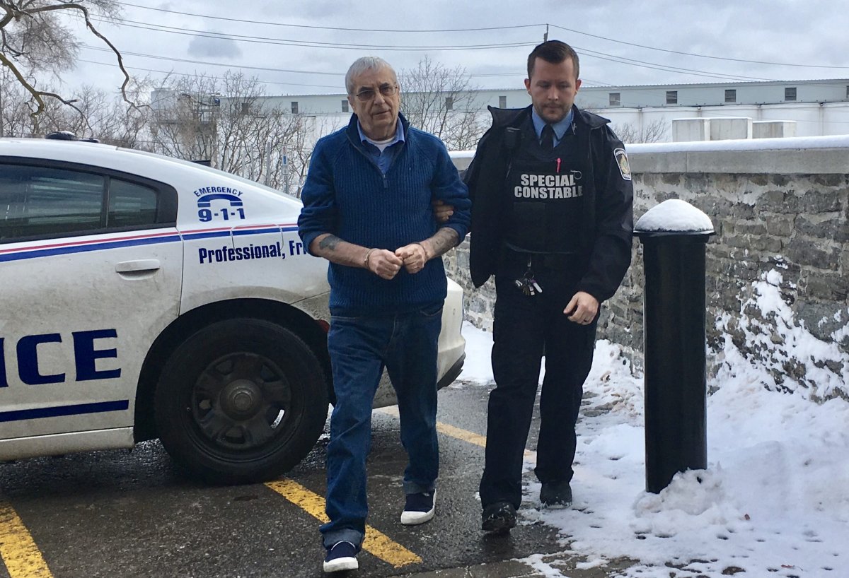 Terrance Finn, left, is lead to Superior Court in Peterborough for his murder trial on Jan. 6, 2020.