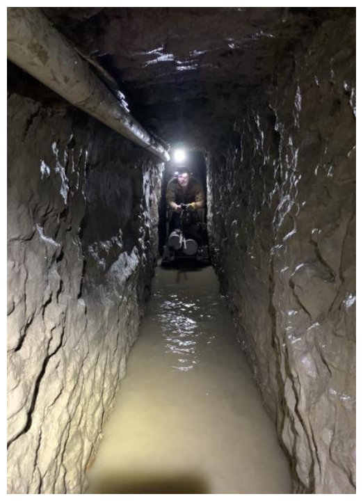 A Customs and Border Protection officer is shown in a tunnel under the U.S.-Mexico border.