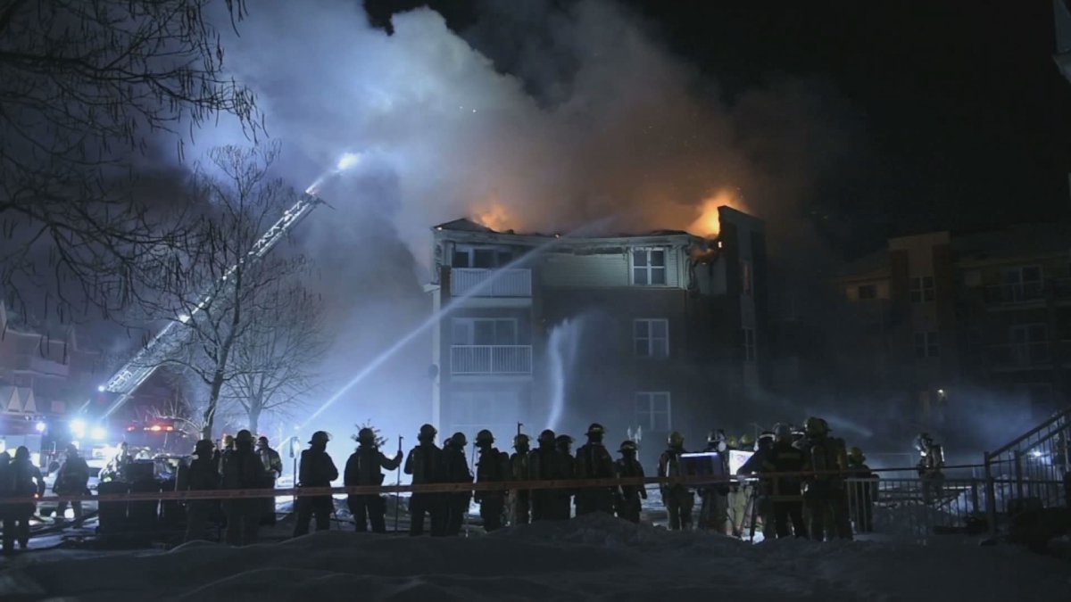 Montreal firefighters battle a four-alarm fire in Pointe-aux-Trembles on Tuesday, Jan. 28, 2020.