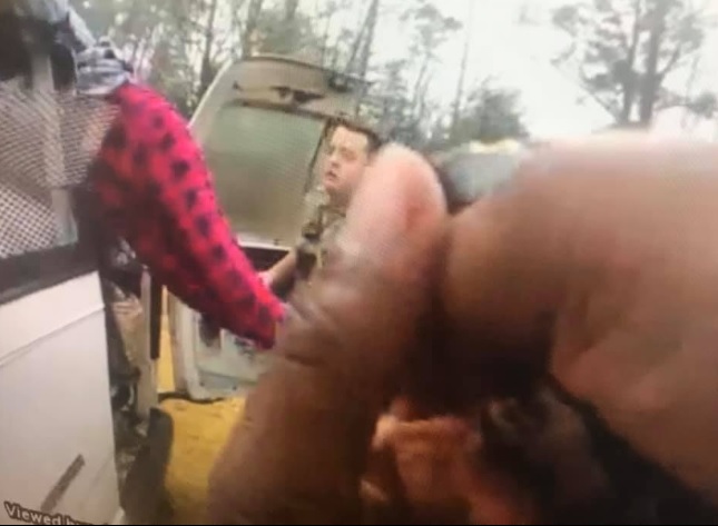 A screenshot image of a kidnapping victim being rescued from a van in Alabama.