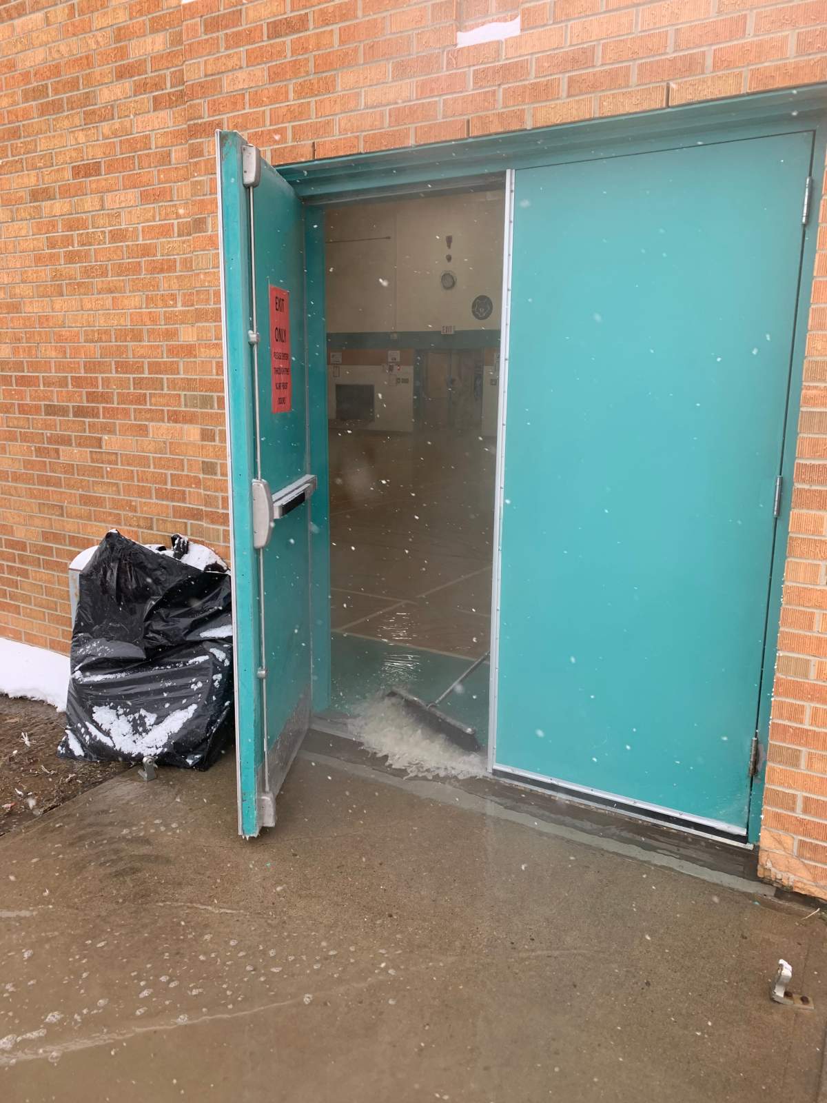 Standing water had to be swept out of the gymnasium at William Grayson School in Moose Jaw.