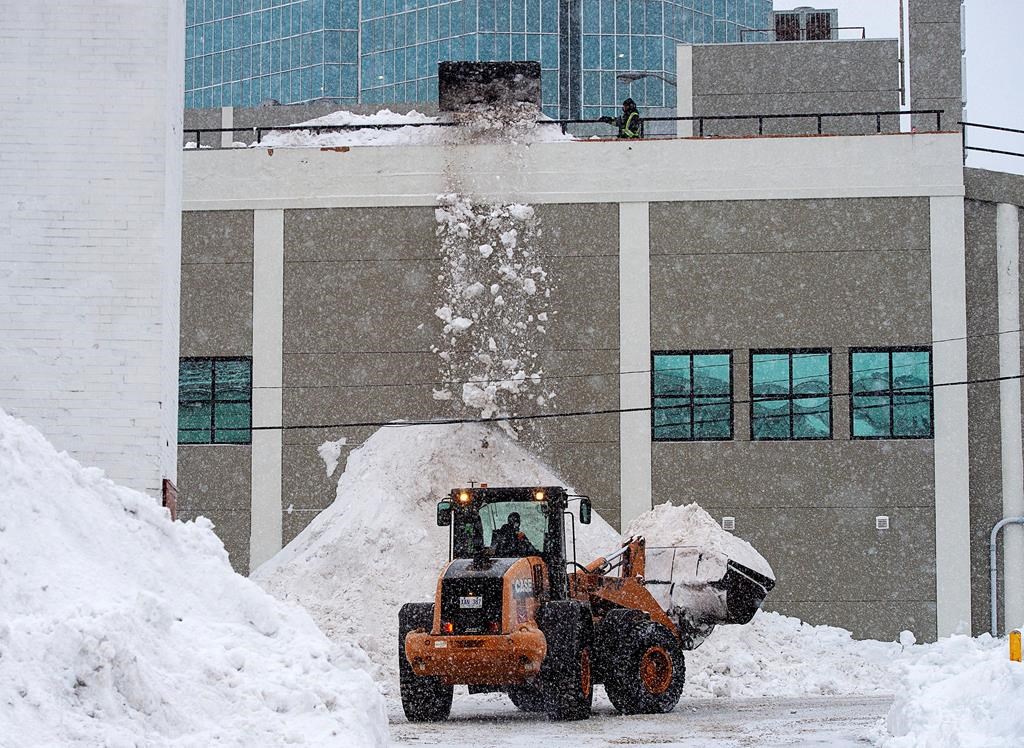 Contractors clear snow from the upper deck of a parking lot in St. John’s on Tuesday, January 21, 2020.