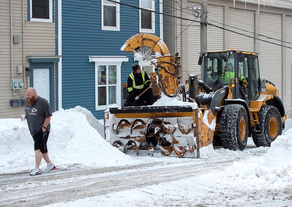 A resident heads back to his home after chatting with workers as they continue to remove snow from the streets in St. John’s on Tuesday, January 21, 2020.
