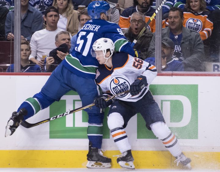Vancouver Canucks defenceman Troy Stecher (51) goes into the boards with Edmonton Oilers right wing Kailer Yamamoto (56) during first period NHL action at Rogers Arena in Vancouver, Wednesday, Jan. 16, 2019. Kailer Yamamoto has only been with the Edmonton Oilers for three games but he’s already seen ice time on the top six.