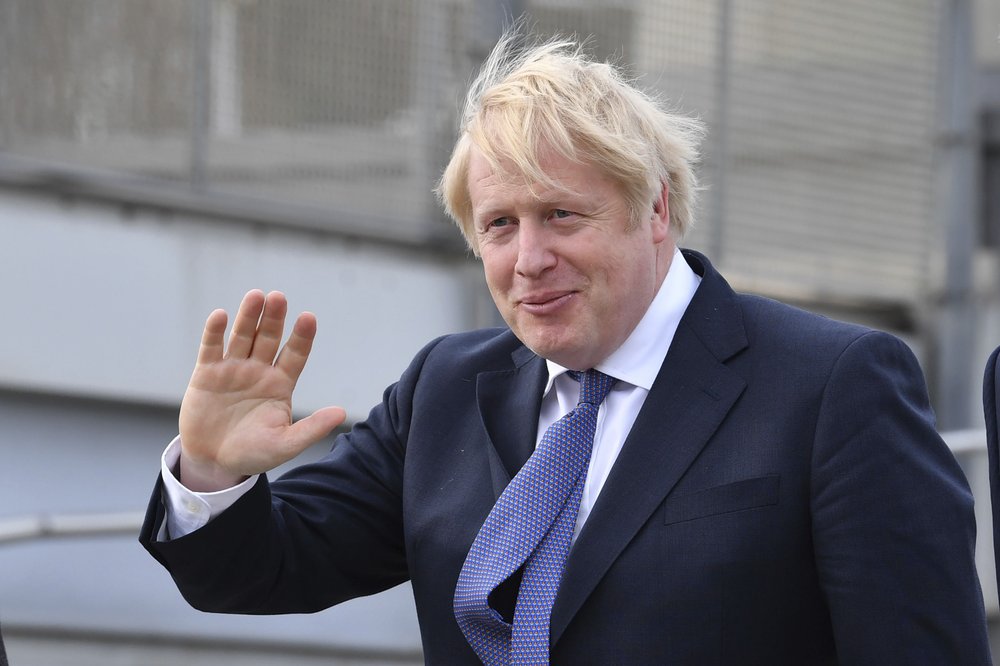Britain's Prime Minister Boris Johnson, center, arrives for a cabinet meeting at National Glass Centre at the University of Sunderland, the city which was the first to back Brexit when results were announced after the 2016 referendum, in England, Friday, Jan. 31, 2020. Britain officially leaves the European Union on Friday after a debilitating political period that has bitterly divided the nation since the 2016 Brexit referendum. 