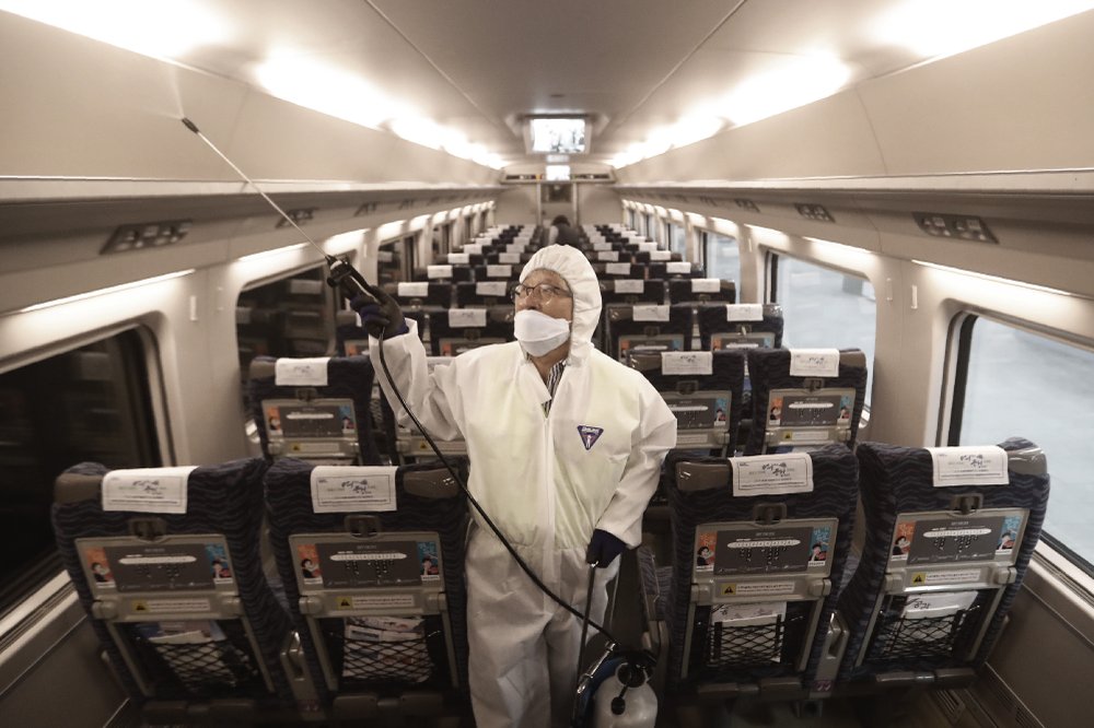 FILE - In this Jan. 24, 2020, file photo, an employee sprays disinfectant on a train as a precaution against a new coronavirus at Suseo Station in Seoul, South Korea. Halting the spread of a new virus that has killed hundreds in China is difficult in part because important details about the illness and how it spreads are still unknown. 