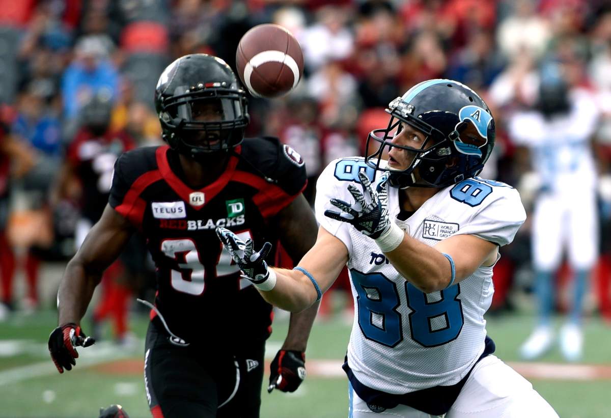 Toronto Argonauts wide receiver Jimmy Ralph (88) makes the catch in front of Ottawa Redblacks defensive back De'Chavon Hayes (34) during first half CFL football action in Ottawa on Saturday, Sept. 7, 2019. 