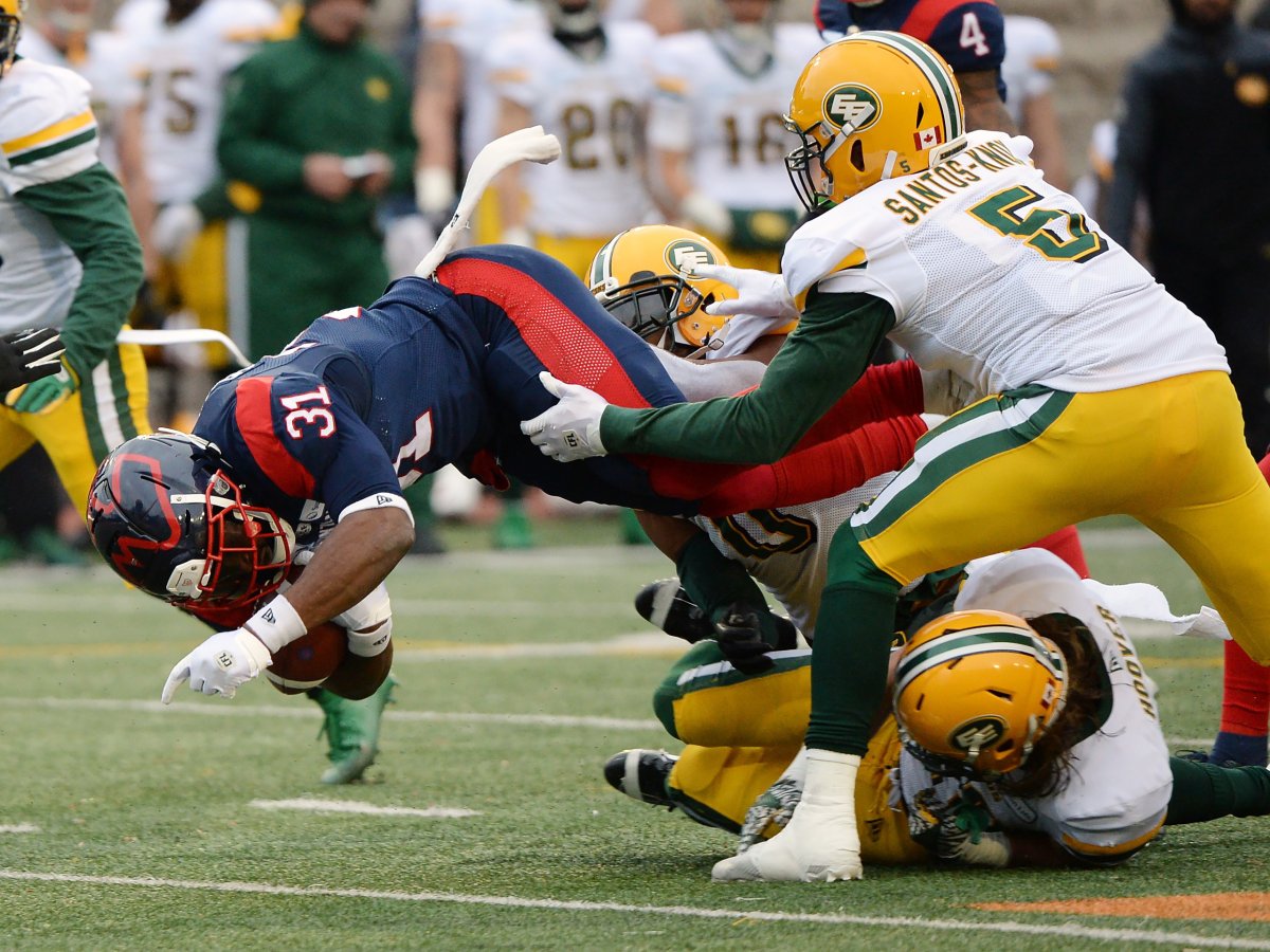 Montreal Alouettes running back William Stanback (31) dives forward for a first down past Edmonton Eskimos linebacker Jovan Santos-Knox (5) during first half football action in the CFL East semifinal in Montreal on Sunday, Nov. 10, 2019. 