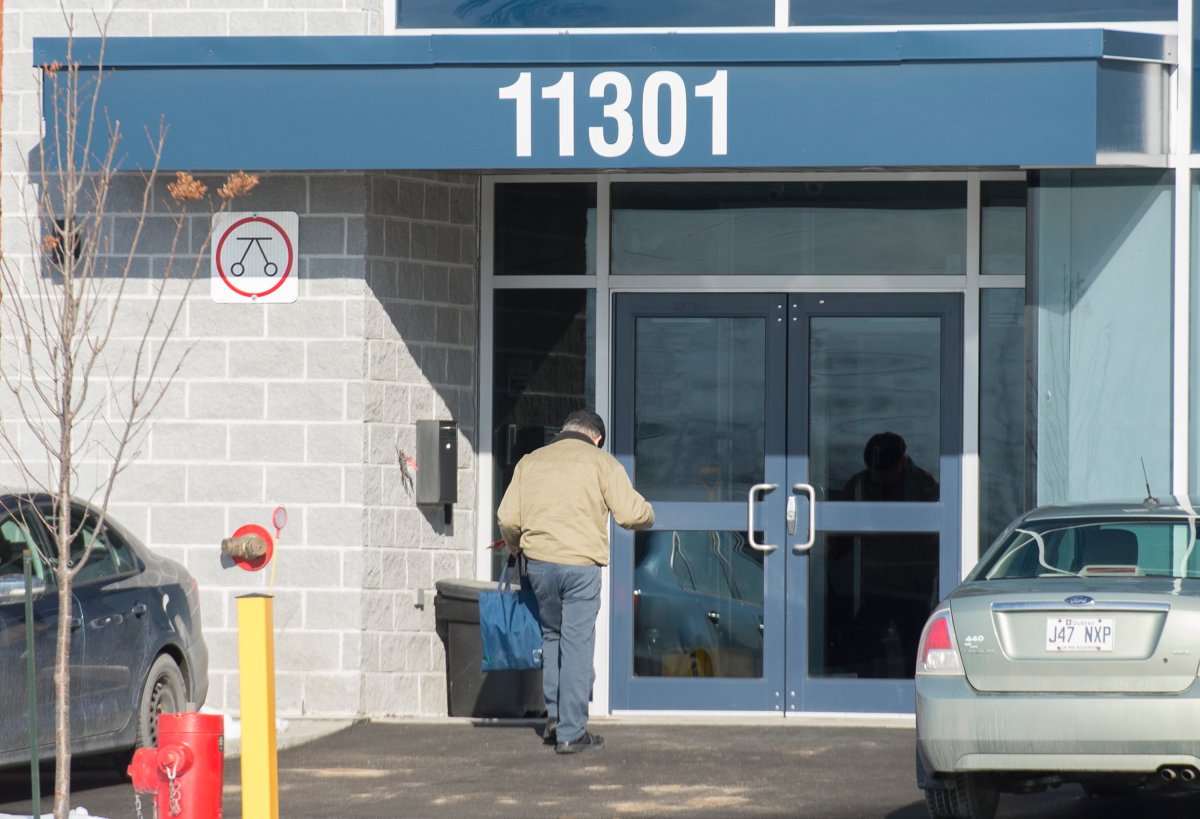 A man enters a building in an industrial park in Montreal, Thursday, November 21, 2019, where it is believed that children attend a school run by a religious group. 