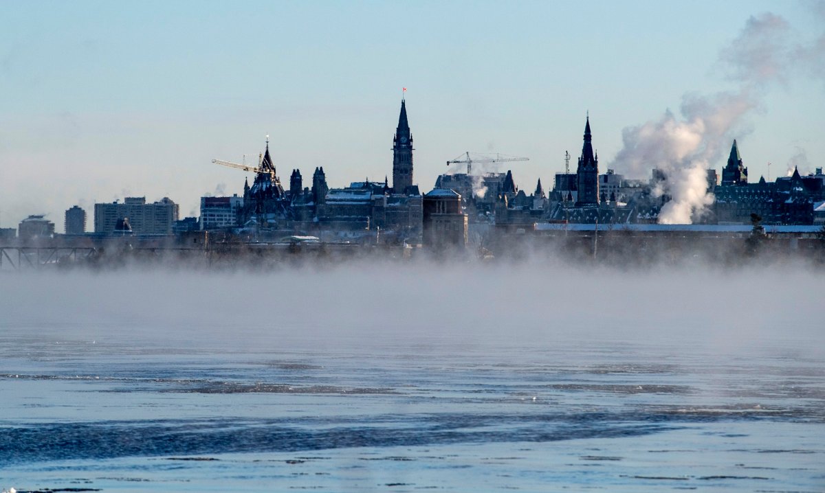 Parliament Hill is seen above mist rising from the Ottawa River as temperatures reached -18 C, -29 with the windchill, in Ottawa on Monday, Jan. 20, 2020.