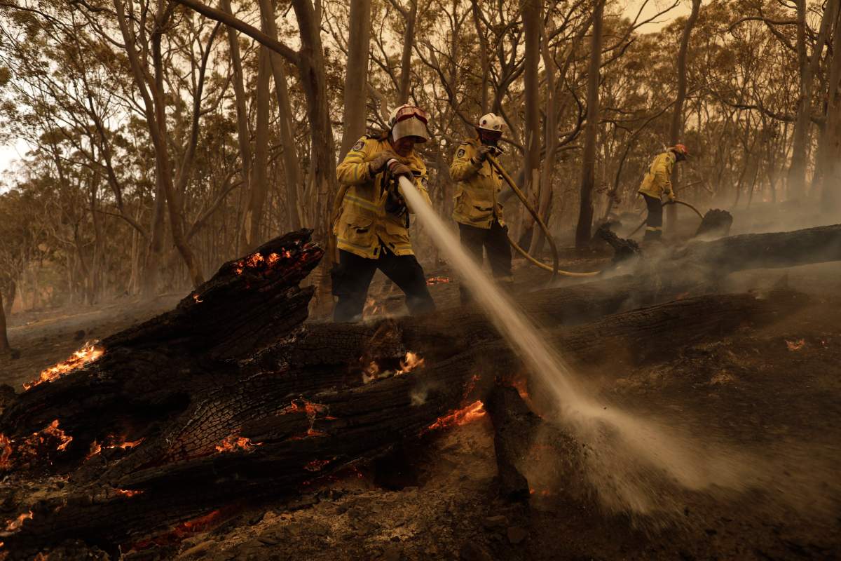 Members of the Sutherland Strike Force Rural Fire Service (RFS) work to contain a spot fire on a property in Colinton, New South Wales, Australia, Feb. 1, 2020.