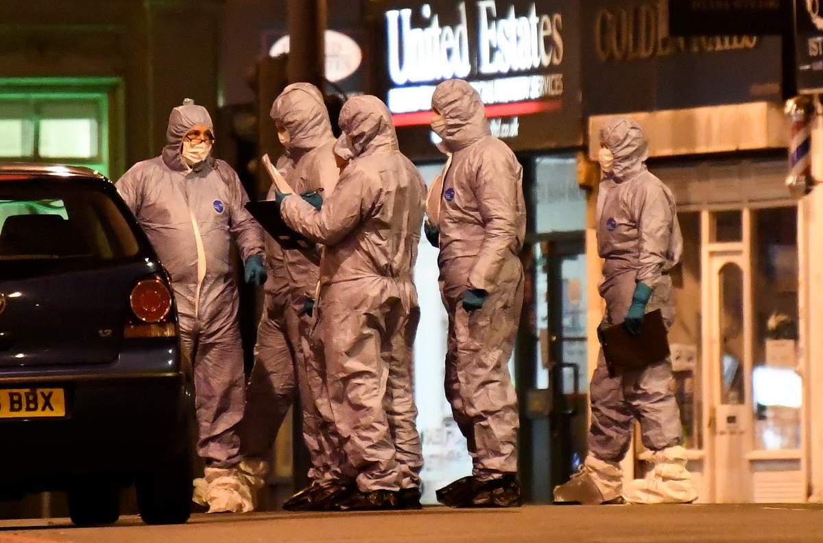 Police forensic officers work near the scene after a stabbing incident in Streatham London, England, Feb. 2, 2020.