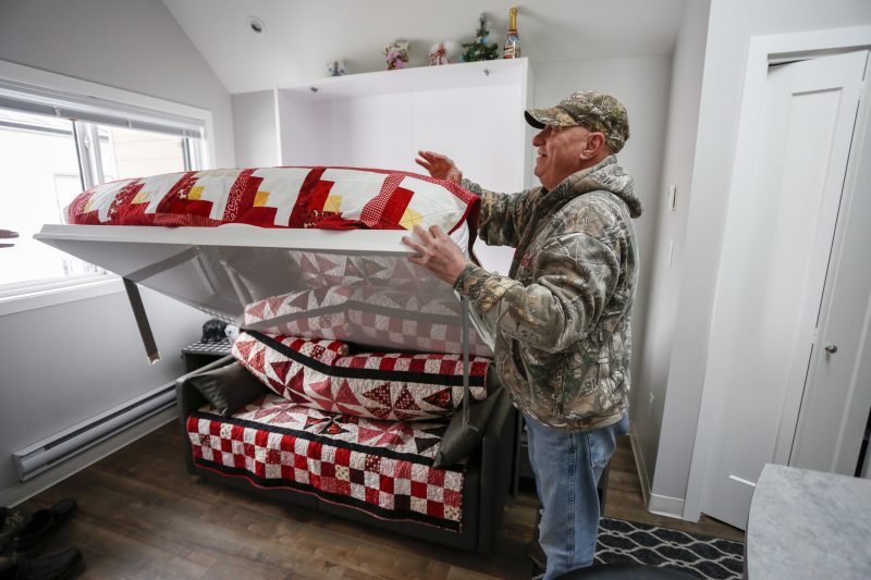 Dirk Lemcke, who served 8 and a half years in a combat regiment with the US military, lowers his Murphy bed in his “tiny home” at the ATCO Village Homes for Heroes in Calgary, Alta., Wednesday, Jan. 29, 2020.