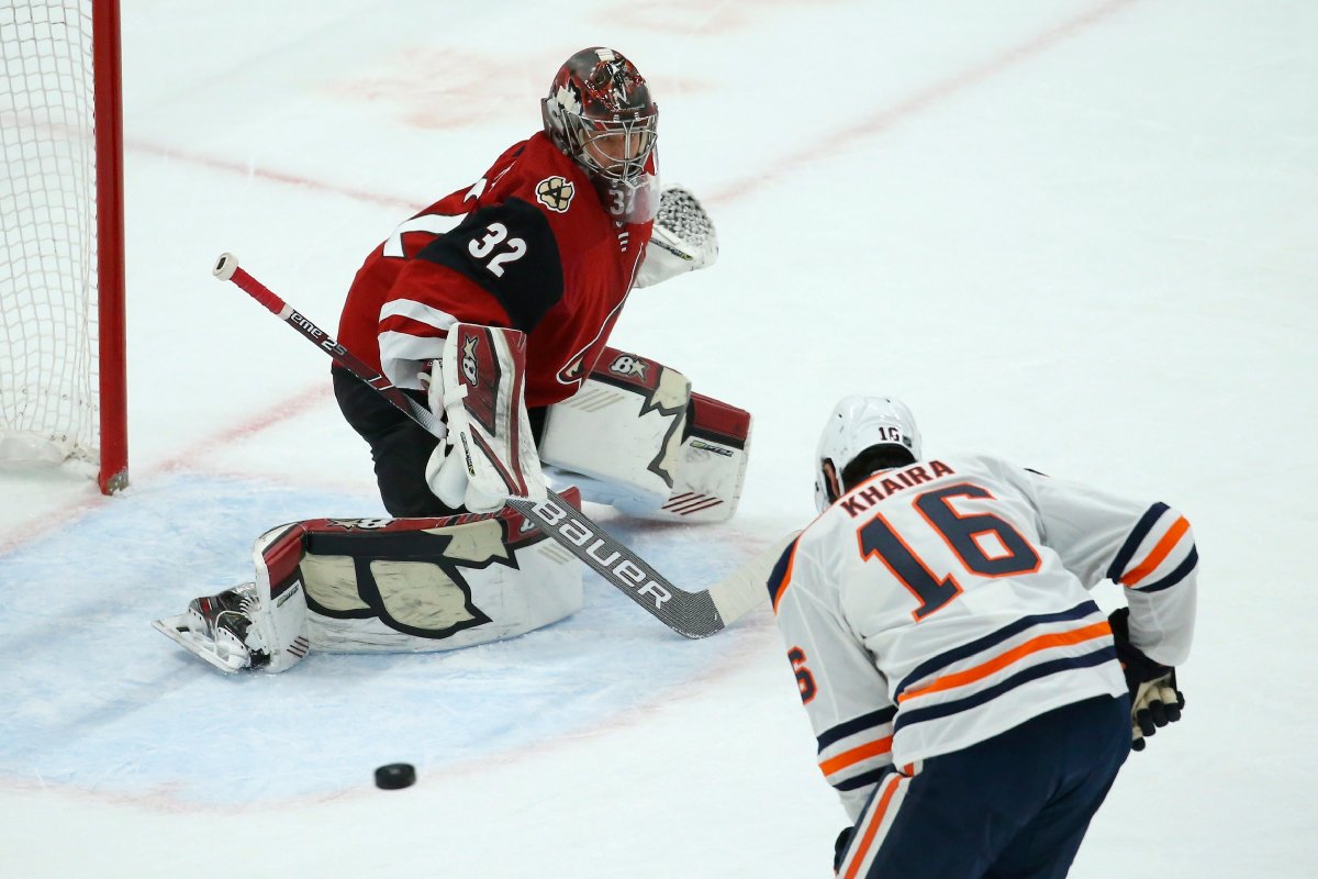 Edmonton Oilers left wing Jujhar Khaira (16) is unable to get to a pass as Arizona Coyotes goaltender Antti Raanta (32) slides over to protect the net during the first period of an NHL hockey game Tuesday, Feb. 4, 2020, in Glendale, Ariz. (AP Photo/Ross D. Franklin).