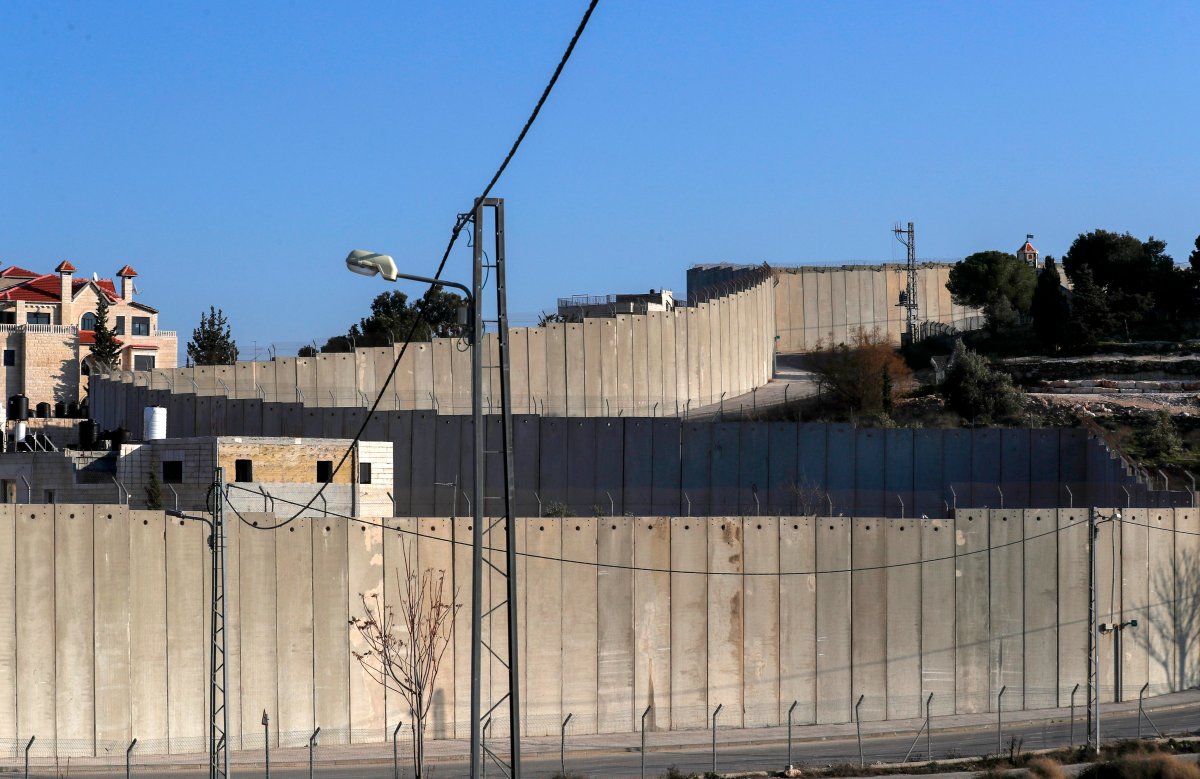 A general view of the Israeli separation barrier between East Jerusalem (R) and the Palestinian town of Abu Dis (L), which is the proposed Palestinian capital in US President Donald Trump's plan for the Middle East, 05 February 2020.
