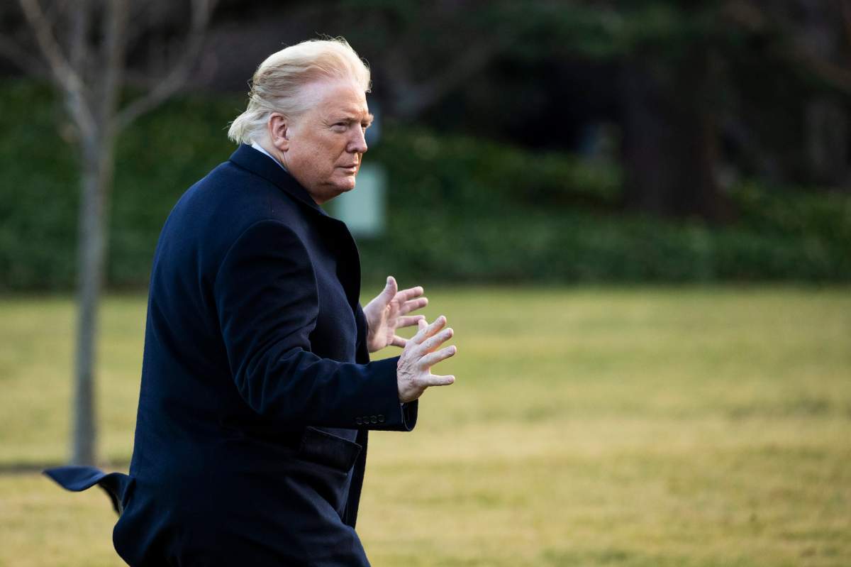 President Donald Trump gestures as reporters ask questions upon arrival to the White House, Feb. 7, 2020, in Washington, as he returns from a trip to Charlotte, N.C.