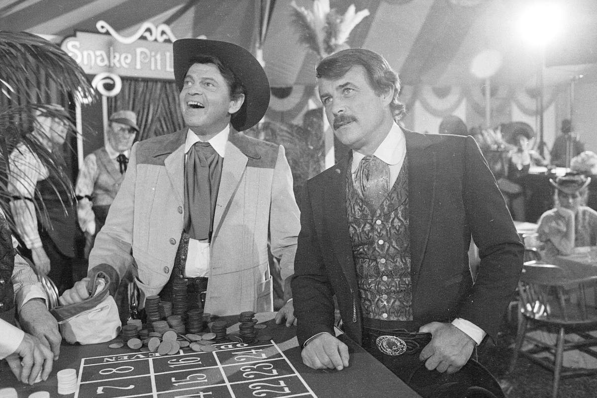 In this June 4, 1980 photo, actors Ross Martin, left, and Robert Conrad, right, are shown while filming a scene of the motion picture “More Wild, Wild West,” in Los Angeles.