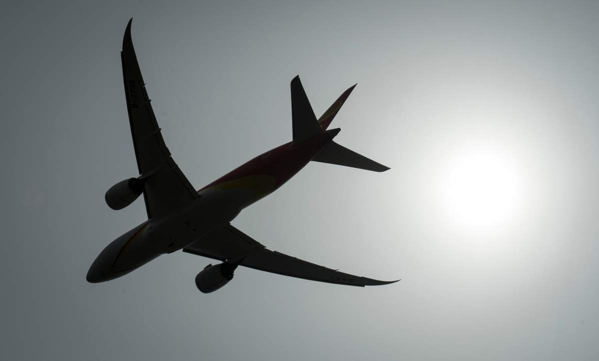 A plane is silhouetted as it takes off from Vancouver International Airport in Richmond, B.C., Monday, May 13, 2019.