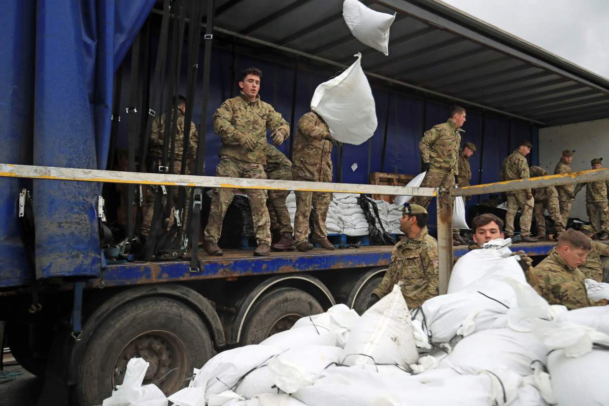 Soldiers from The Highlanders, 4th Battalion, the Royal Regiment of Scotland assist with flood defences as the UK prepares for widespread weather disruption as Storm Dennis approaches, in Mytholmroyd, West Yorkshire, England, Saturday, Feb.15, 2020.