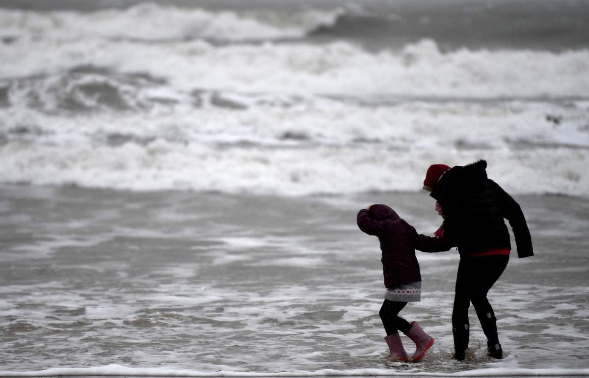 People walk by the sea in Bournemouth, Britain, 15 February 2020.