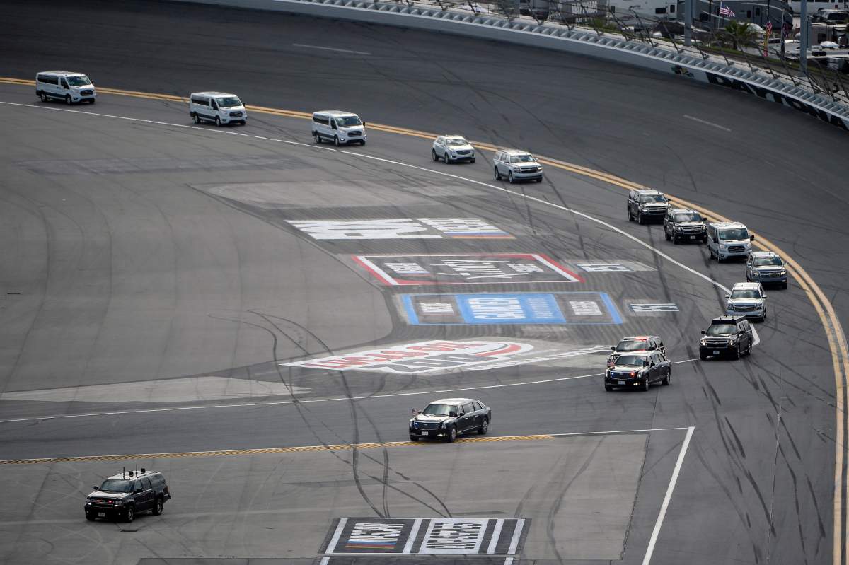 The motorcade with President Donald Trump makes its way through Turn 1 after arriving at Daytona International Airport before the NASCAR Daytona 500 auto race at Daytona International Speedway, Sunday, Feb. 16, 2020, in Daytona Beach, Fla.