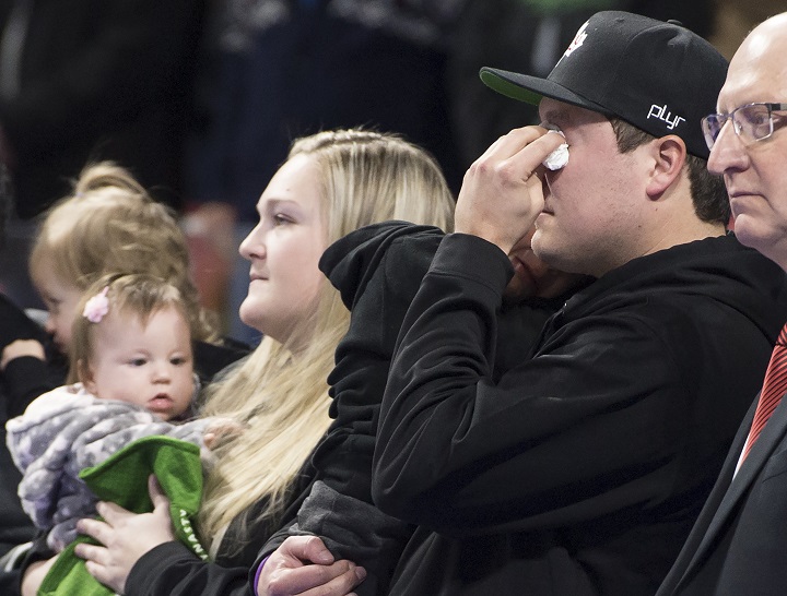 Scott Jenkins, husband of the late Saskatchewan player Aly Jenkins, reacts alongside family including his three children Brady, Avery and Sydney during a tribute to his wife prior to the 4th draw at the Scotties Tournament of Hearts in Moose Jaw, Sask., Sunday, Feb. 16, 2020.