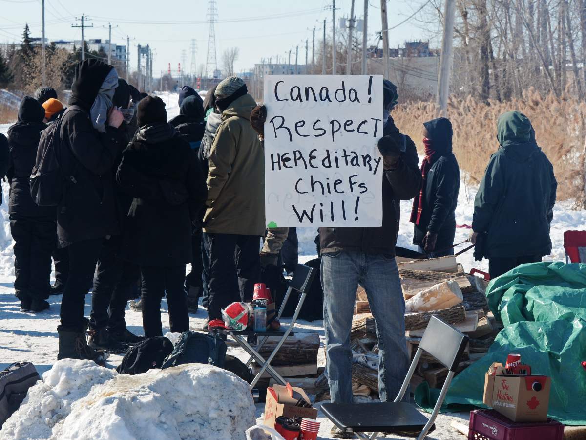 People protest at a rail blockade in St-Lambert, south of Montreal, Que. on Thursday, February 20, 2020 in solidarity with the Wet'suwet'en hereditary chiefs opposed to the LNG pipeline in northern British Columbia.