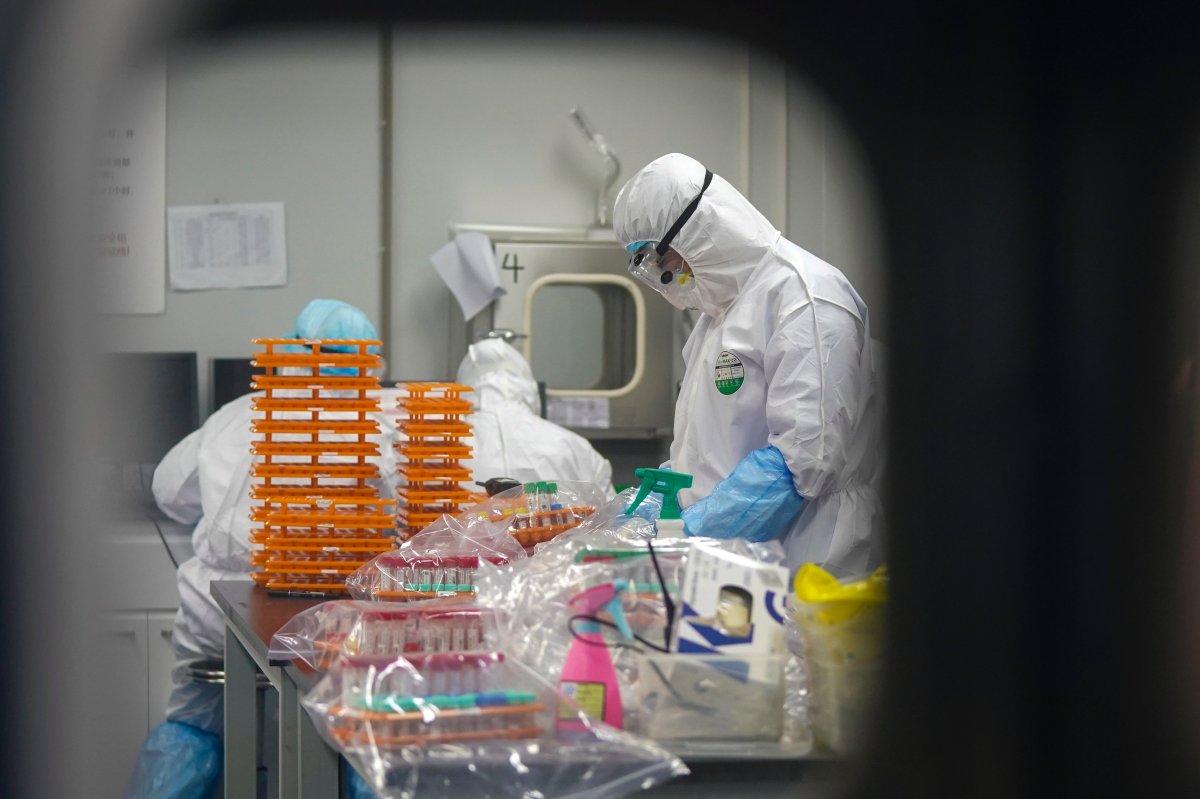 This Saturday, Feb. 22, 2020, photo released by Xinhua News Agency, shows medical workers in protective suits at a coronavirus detection lab in Wuhan in central China's Hubei Province. 