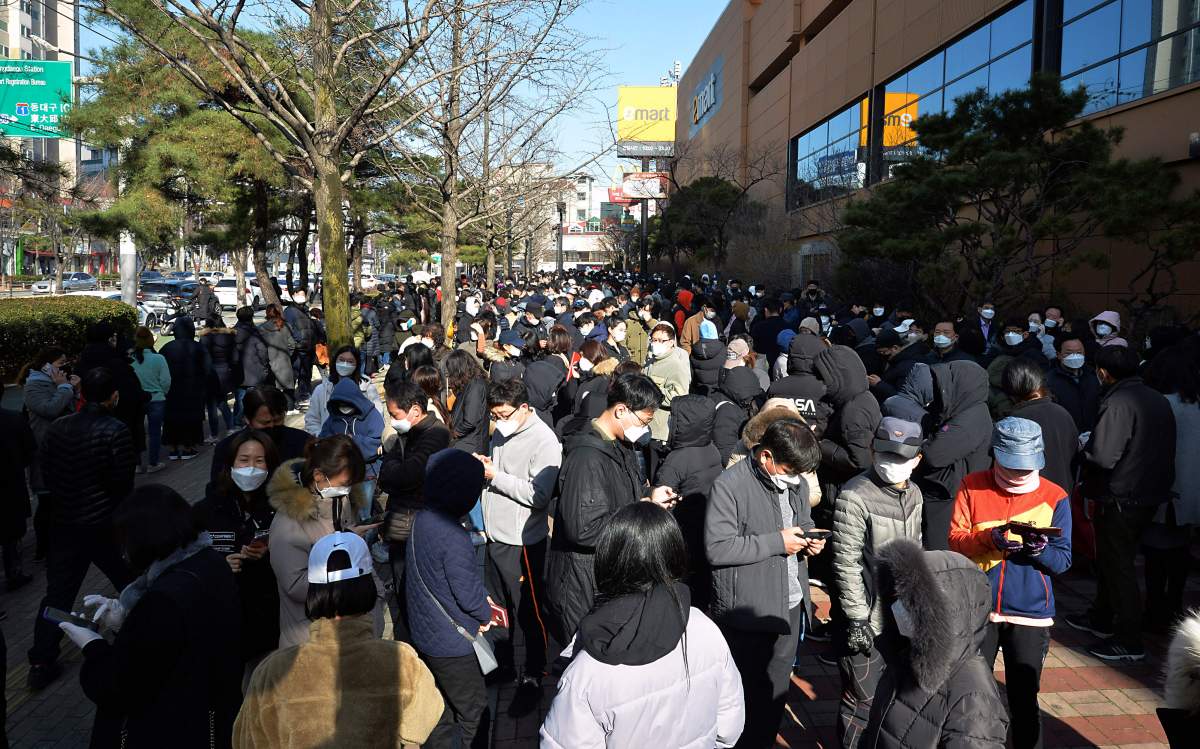 People line up to buy face masks at a store in Daegu, South Korea, Monday, Feb. 24, 2020. South Korea's President Moon Jae-in on Sunday put the country on its highest alert for infectious diseases and says officials should take "unprecedented, powerful" steps to fight a viral outbreak. (Lee Moo-ryul/Newsis via AP).
